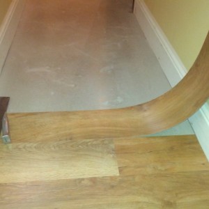 using straight edge to cut one end to first wall...