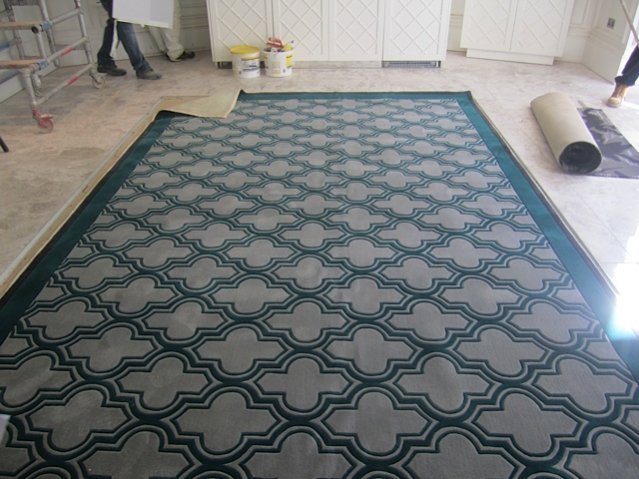 This is what happens when a designer orders the hand made rugs from the plans,without remeasuring on site, only 100mm short for both rooms